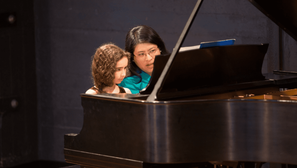 woman teaching piano at east bay center